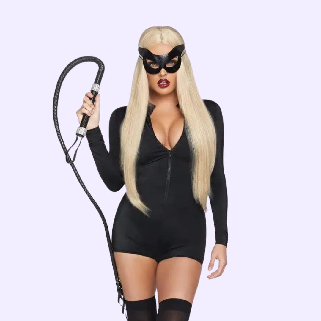 Model wearing black fetish bodysuit and mask holding a whip for bondage accessories promotion.
