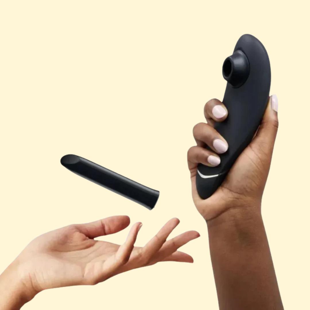 Hands displaying black vibrators for vibrator sale promotion.
